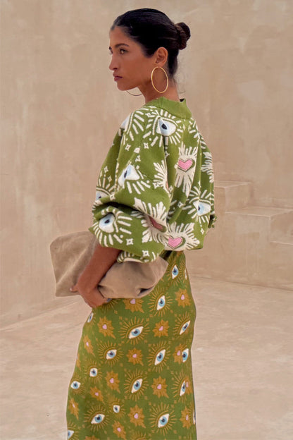 Khaki Eye Cardigan featuring embroidered eye and heart motifs, styled with a matching knitted skirt.