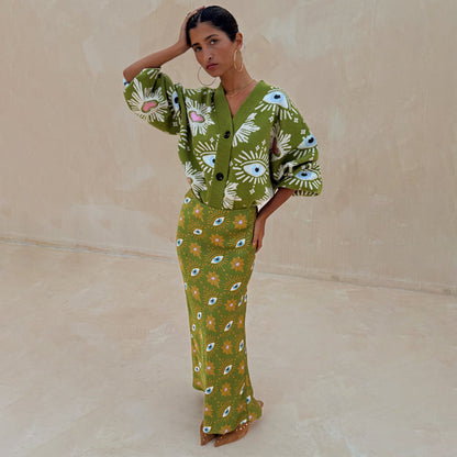 Khaki Eye Dorris Skirt featuring mystical eye and heart prints, styled with a matching green cardigan.