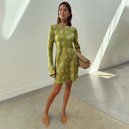 Khaki Eye Mini Soho Dress in green featuring the iconic NFD eye print, flared sleeves, and an hourglass silhouette.