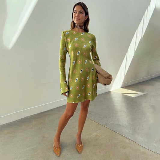 Khaki Eye Mini Soho Dress in green featuring the iconic NFD eye print, flared sleeves, and an hourglass silhouette.