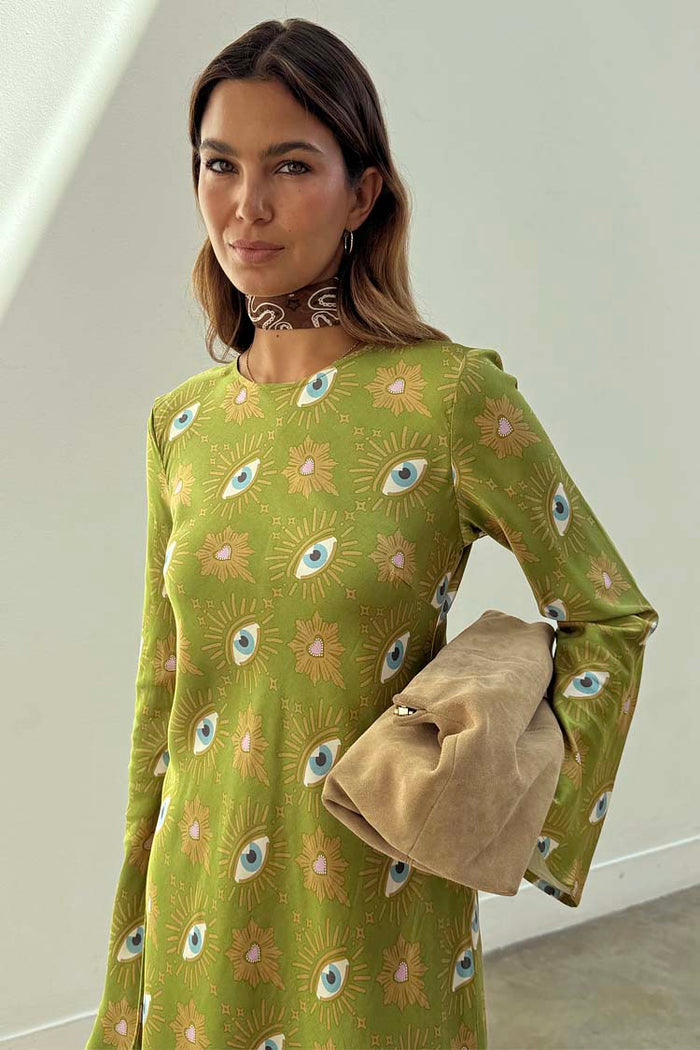 Khaki Eye Mini Soho Dress Petite with the iconic green eye print, flared sleeves, a neck scarf and tan clutch bag.