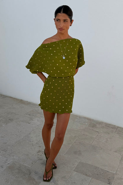 Khaki mini plisse Tilly dress with gold flecks and an elasticated waist seam on a model.