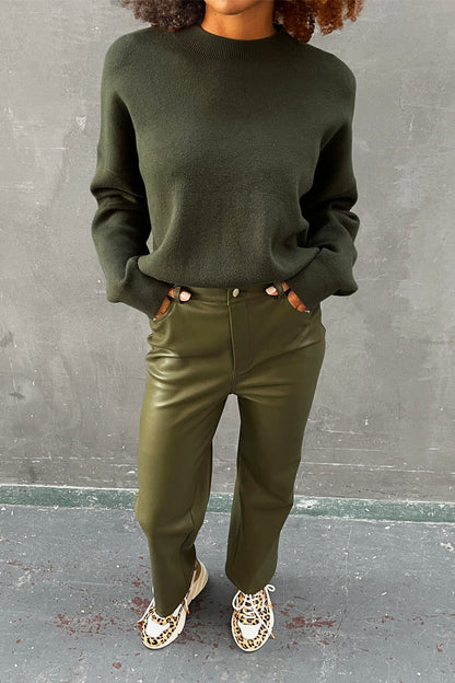 Khaki Vegan Leather Trousers with a dark green jumper and leopard print trainers.