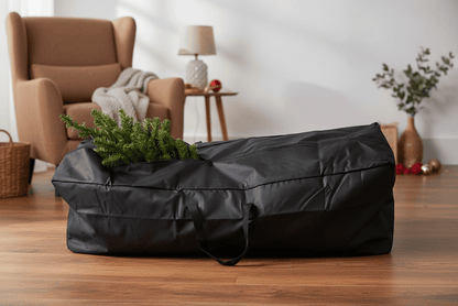 Black storage bag with a Christmas tree on a wooden floor in a living room.