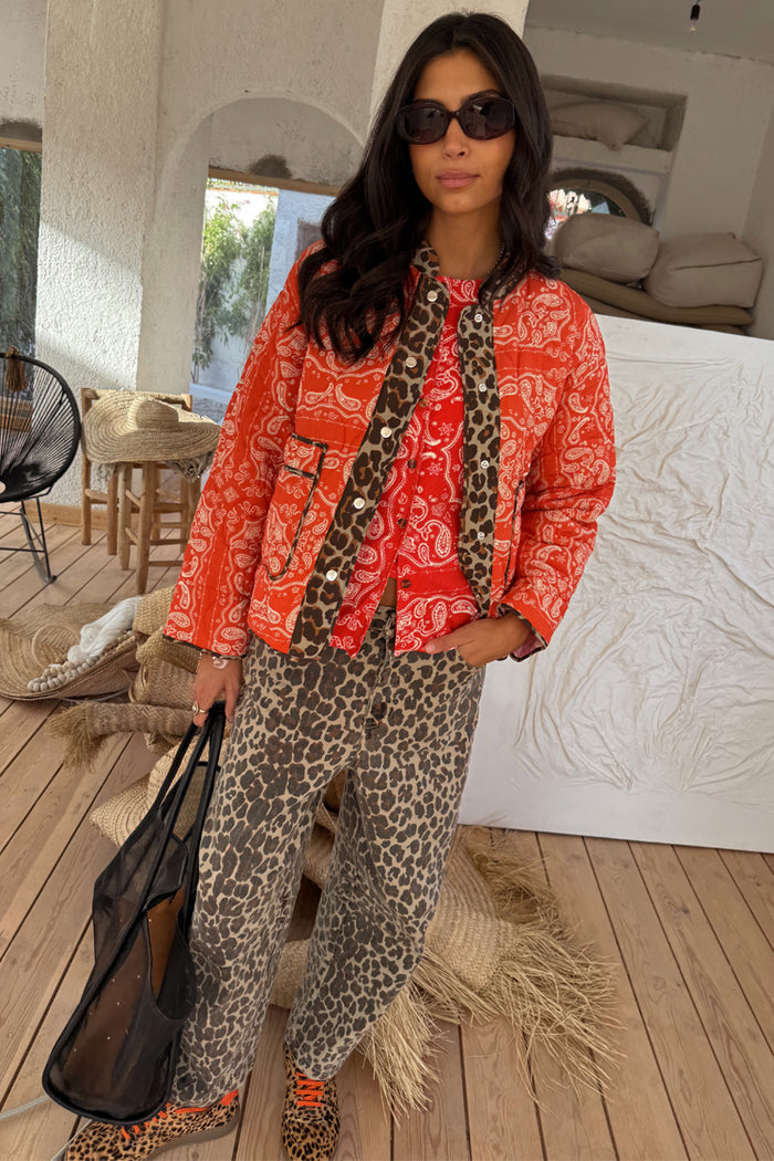 Iconic Leopard Barrel Jeans with a relaxed barrel leg, paired with a red paisley quilted jacket.
