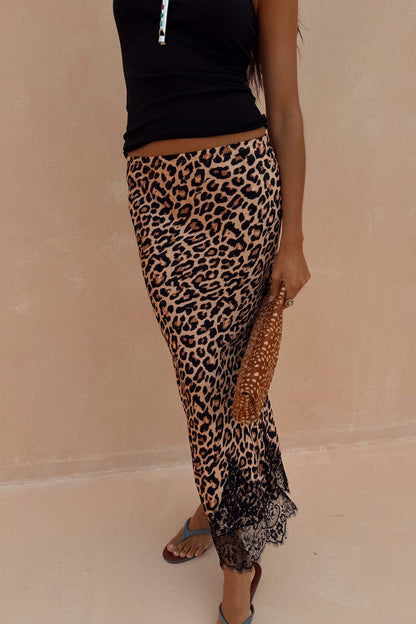 Leopard print Midi Maeva Skirt with a black lace border, styled with a black top and matching patterned clutch.