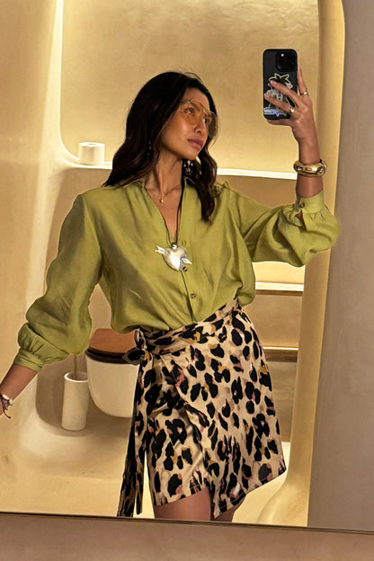 Iconic Leopard Mini Jaspre wrap skirt styled with a lime green shirt in a stylish mirror selfie.