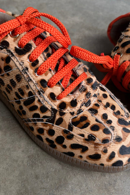 Leopard Pony Trainer featuring an iconic leopard print leather upper and contrasting orange laces.