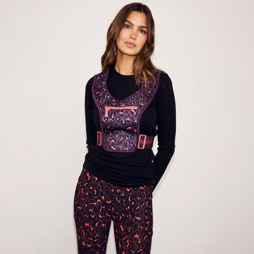 Iconic Leopard Running Bag in dark purple print with coral zips, styled with matching print leggings.