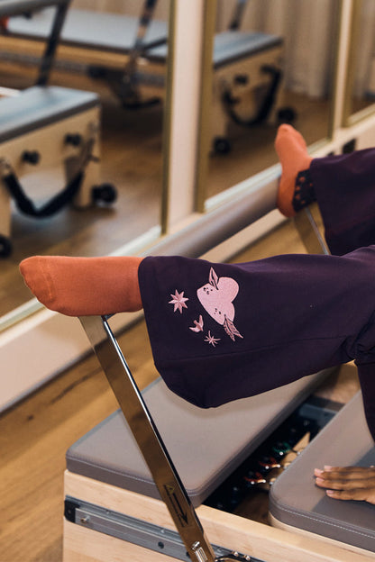 Orange cotton NFD socks worn on a Pilates reformer, ideal for gym sessions and activewear styles.