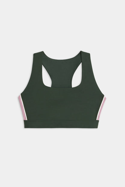 The SPLITS59 Lexi Rigor Bra, a dark green racerback sports bra featuring pink and white side stripes, is displayed on a white background.