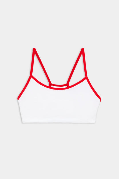 White bralette with thin red straps and red trim, displayed on a plain light gray background.