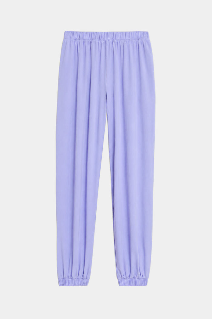 The SPLITS59 Megan Woven Nylon Jogger in Purple Haze features soft nylon spandex fabric, an elastic waistband and cuffs, and is shown against a white background.