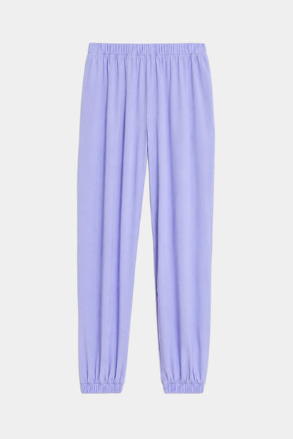 The SPLITS59 Megan Woven Nylon Jogger in Purple Haze features soft nylon spandex fabric, an elastic waistband and cuffs, and is shown against a white background.