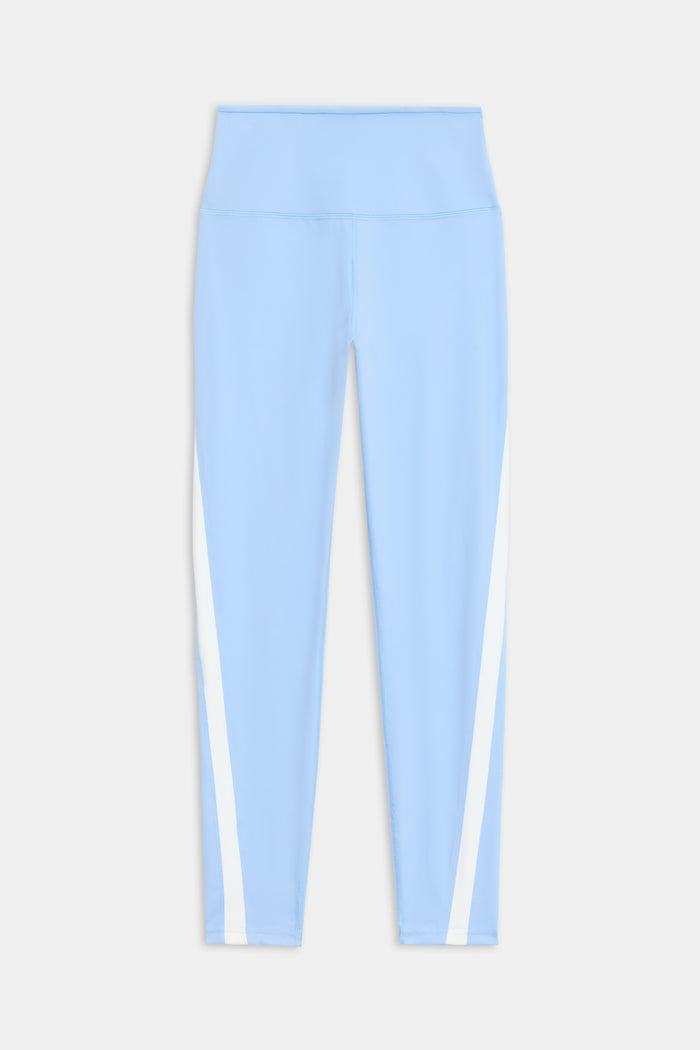 The Miles High Waist Rigor 7/8 leggings by SPLITS59 are light blue with a high waistband and white vertical side stripes, displayed flat against a white background.