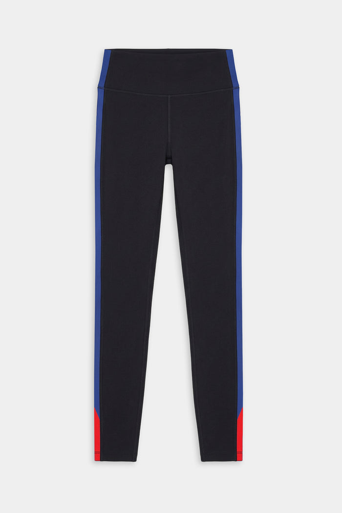The SPLITS59 Monah High Waist Rigor Legging 7/8 in Black/Cobalt features blue side stripes and red lower leg accents on a nylon-spandex blend, showcased against a plain white background.
