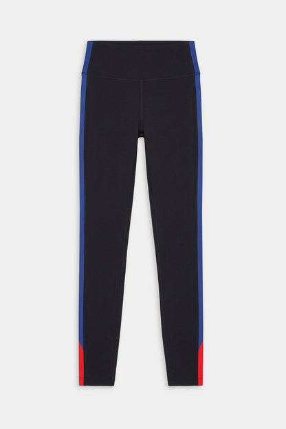 The SPLITS59 Monah High Waist Rigor Legging 7/8 in Black/Cobalt features blue side stripes and red lower leg accents on a nylon-spandex blend, showcased against a plain white background.