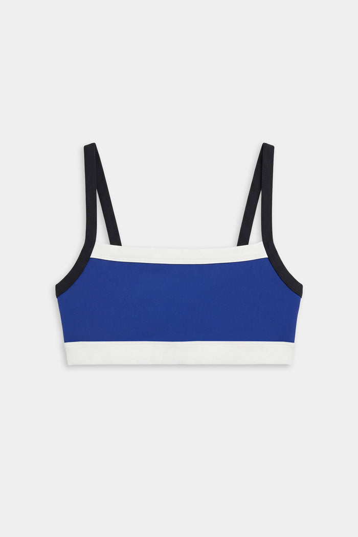 The SPLITS59 Monah Rigor Bra - Cobalt/Black features a blue base with black straps and white trim, showcased against a white background.