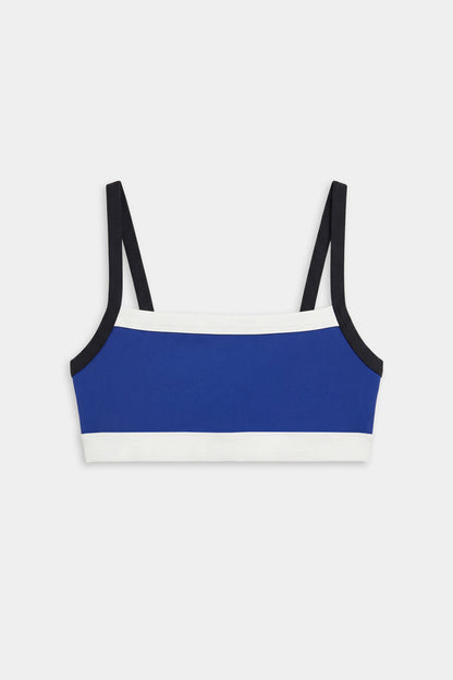 The SPLITS59 Monah Rigor Bra - Cobalt/Black features a blue base with black straps and white trim, showcased against a white background.