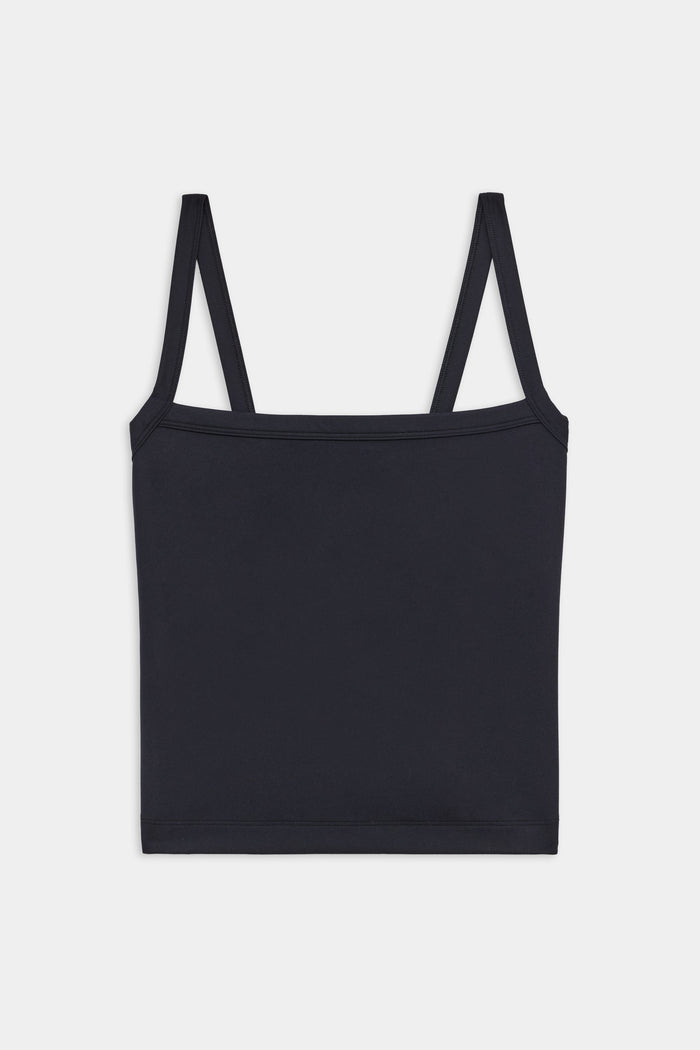 A plain black spaghetti strap tank top laid flat against a white background.