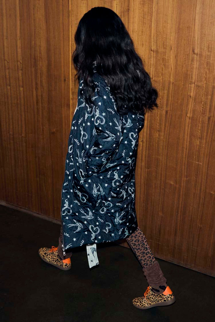 Mono Swallow Romance Reversible Coat with a black and white swallow print, shown on a model walking.
