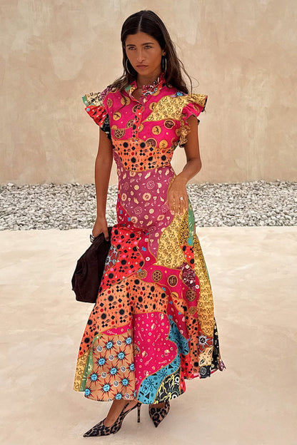 Morocco Remi Dress in a multi-coloured patchwork abstract print with pleated frills and an asymmetrical midi skirt.