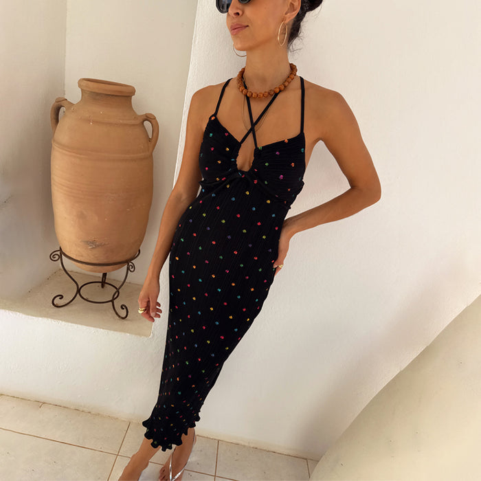 Multi Spot Megan Dress in black plisse with colourful flecks and a strappy cross-front neckline on a model.