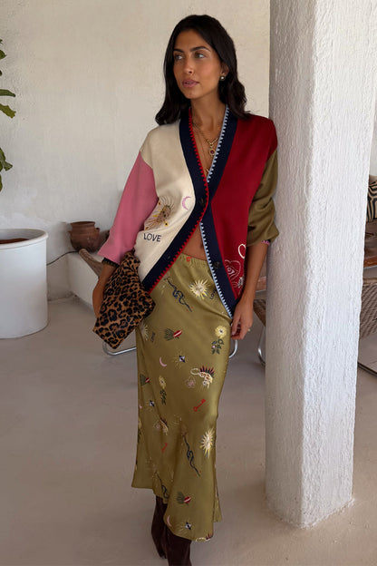 Mystical Martha Cardigan in a multicoloured soft-touch knit, styled with a matching olive skirt and leopard clutch.