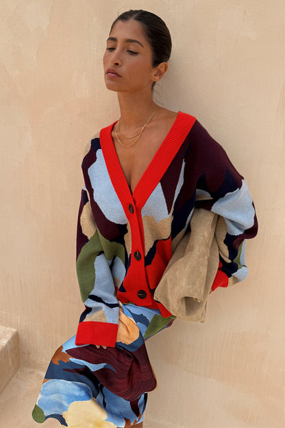 Navy Abstract Callie Cardigan in an iconic artist print with red ribbed trims and button-up front on a model.