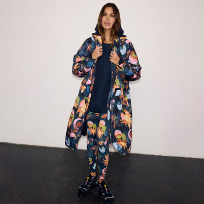 Navy Charm Coat with a colourful sun and moon print, waterproof fabric and borg lining.