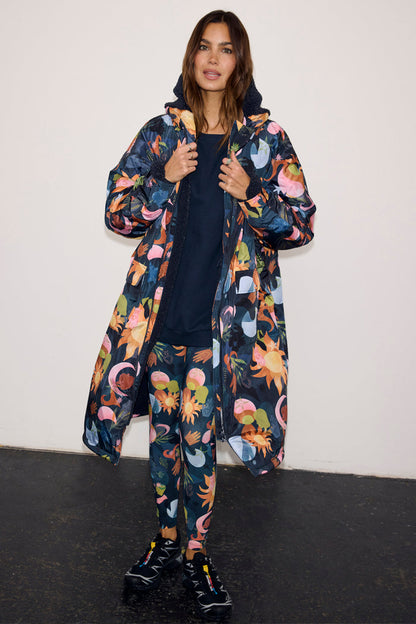 Navy Charm Coat with a colourful celestial print, featuring a cosy borg lining and waterproof fabric.