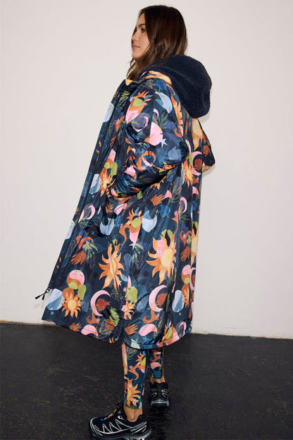 Navy Charm Coat with a hand-painted charm print and a navy borg-lined hood, styled with matching printed leggings.