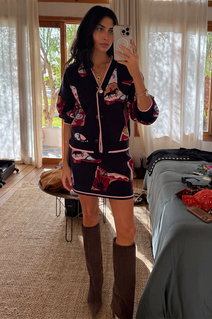 Navy Cowboy Boots Jake knit mini skirt featuring pink contrast trim and cowboy motifs, styled as a matching co-ord.