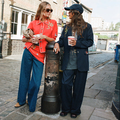 Navy Pinstripe Arden Trousers and matching blazer styled for a coordinated London look.