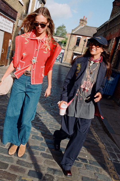 Navy Pinstripe Arden Trousers and matching blazer styled with a graphic tee for a London street style look.