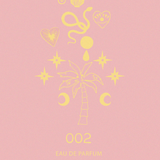 NFD Eau De Parfum 002 graphic print in pink and yellow featuring a central palm tree, crescent moons and celestial stars.