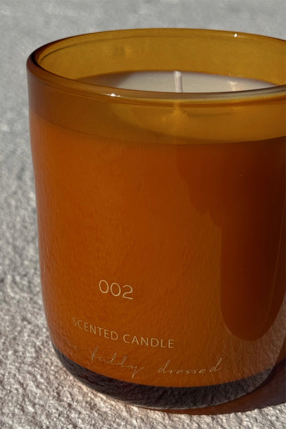 NFD Eau De Parfum Candle 002 in a mandarin-toned glass jar with signature branding.