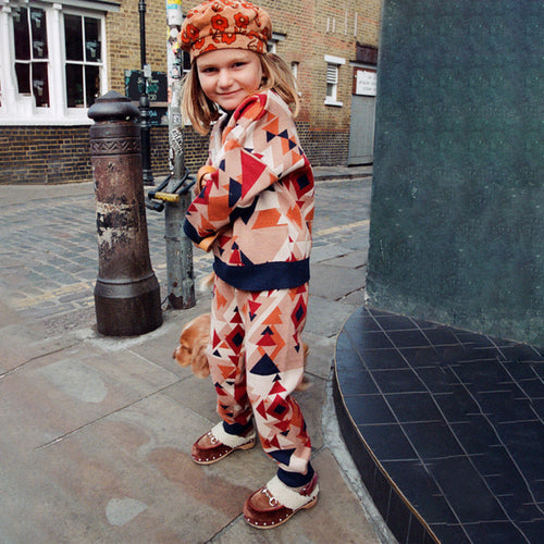 NFD Kids Aspen geometric print knitted jumper and joggers worn by a girl on a London street.