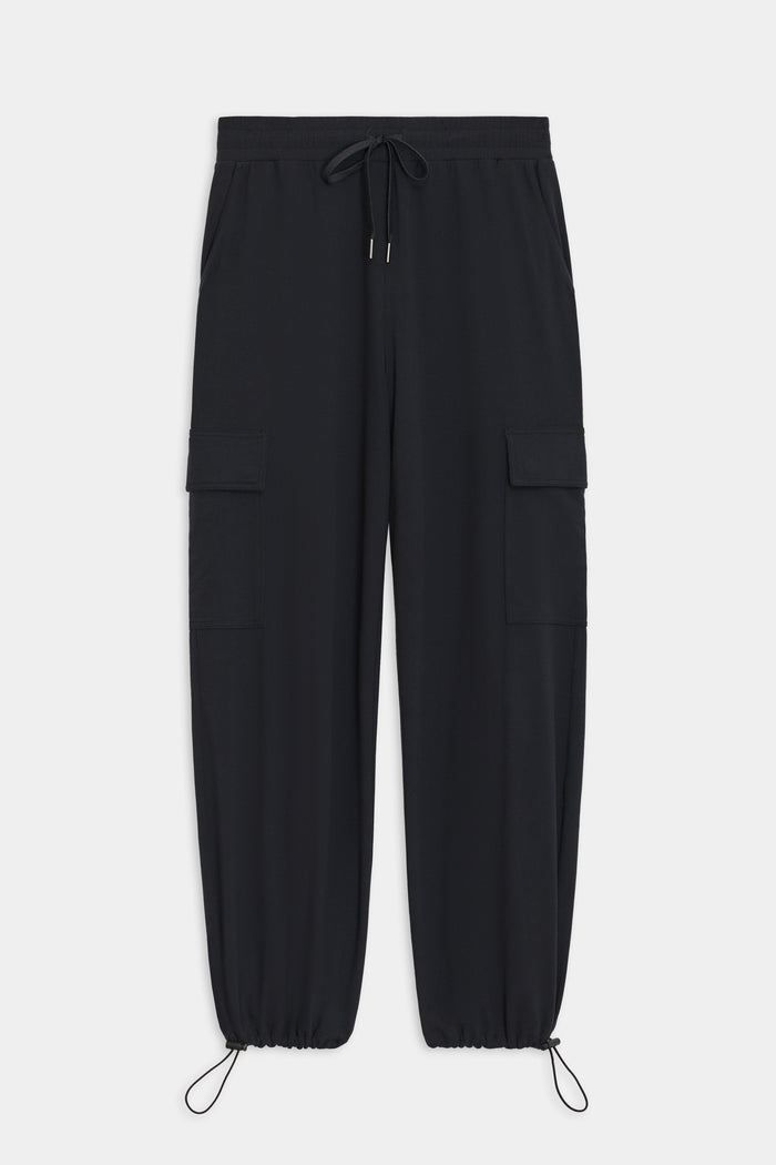 The Nico Airweight Cargo Pant by SPLITS59, in black, features a relaxed fit with side pockets and elastic cuffs. Made of lightweight Airweight fabric, these pants offer ultimate comfort and style for everyday wear, displayed flat on a white background.