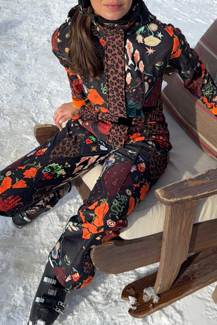 Night Garden Ski Suit with iconic leopard and poppy prints, designed in-house, worn by a model in a snowy setting.