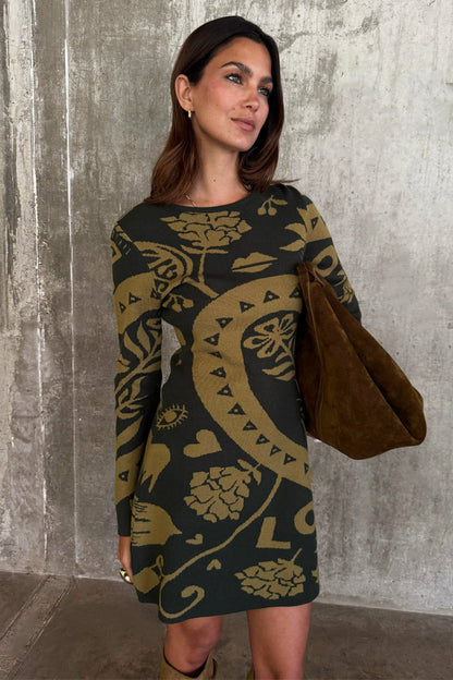 Olive Amara Knit Mini Dress featuring iconic motifs on a soft khaki knit base, paired with a suede bag.