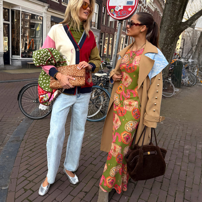 Olive Buckles Mesh Dress featuring western motifs, layered under a tan trench coat for a London look.