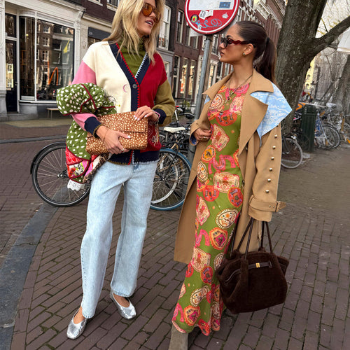 Olive Buckles Mesh Dress featuring western motifs, layered under a tan trench coat for a London look.