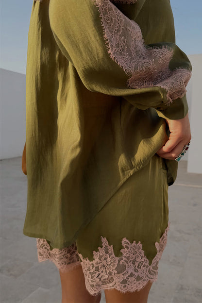 Olive green satin shorts featuring a contrast pink lace hem, styled with the matching lace-trimmed shirt.