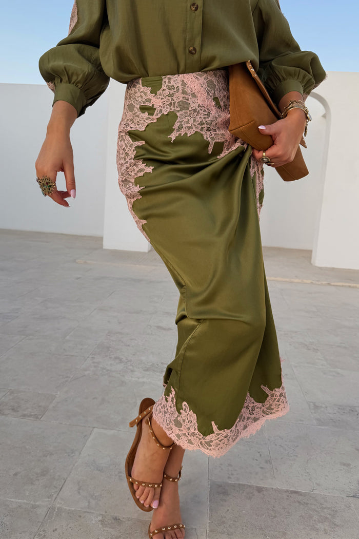 Olive & Pink Lily Skirt in olive green satin with pink lace trim, styled as a midi length with brown sandals.