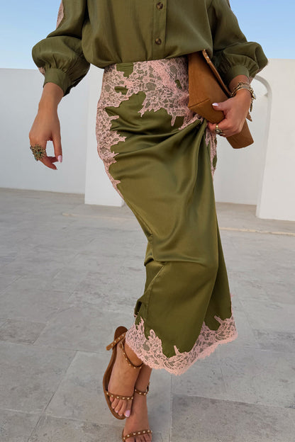 Olive & Pink Lily Skirt in olive green satin with pink lace trim, styled as a midi length with brown sandals.
