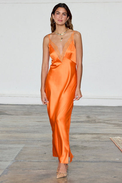 Orange Lily Dress in silky satin featuring a deep V-neckline with sheer lace trim.