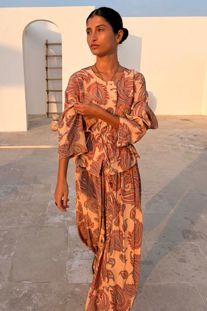 Paisley Anna Top in peach with a tie waist and matching co-ord trousers in a sunlit setting.