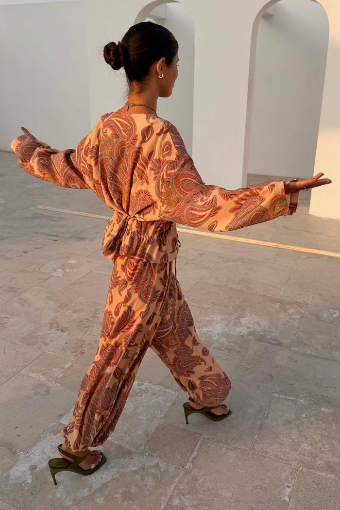 Peach Paisley Anna Top and matching balloon trousers co-ord featuring a tie waist and long sleeves.