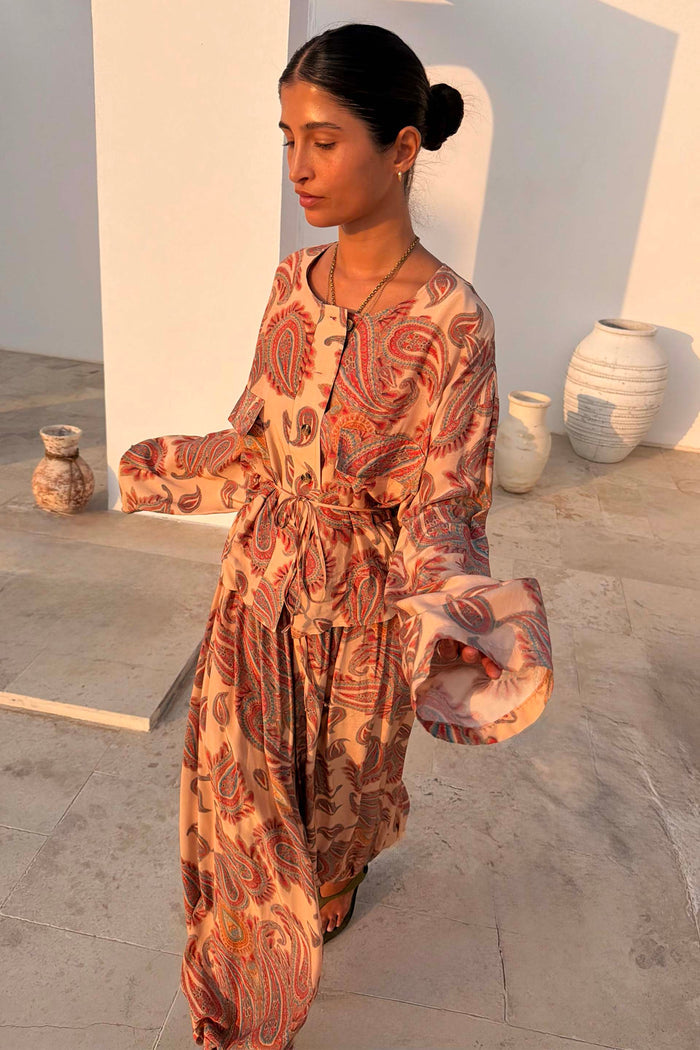 Peach Paisley Anna Top with a tie waist and long sleeves, styled as a co-ord with matching balloon trousers.
